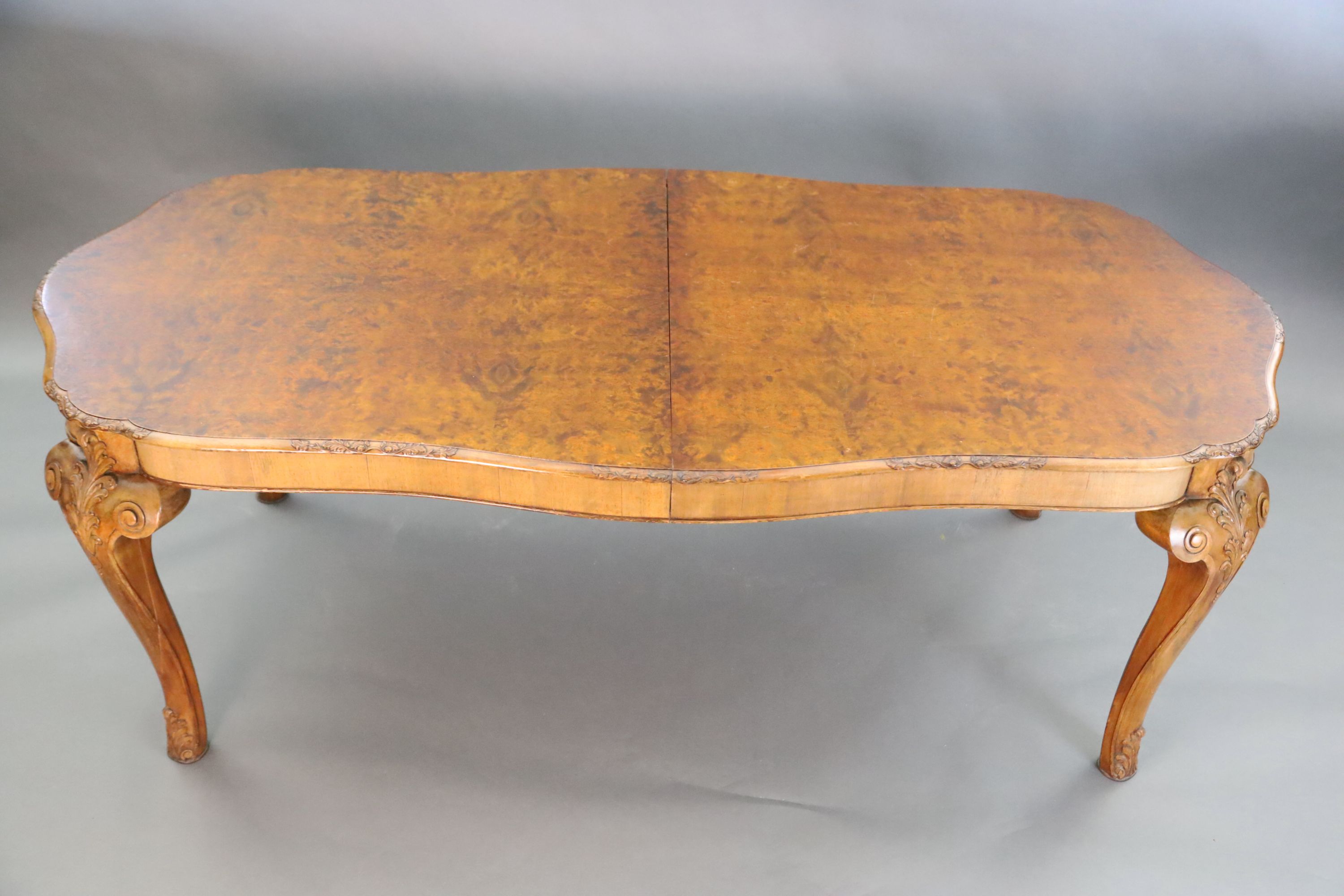 A Queen Anne style burr walnut extending dining table, W.3ft 5in. L.6ft 10in. extends to 8ft 10in. H.2ft 6in.